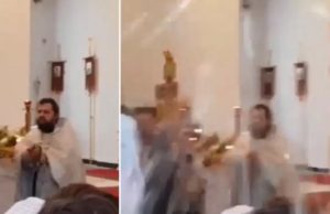 Un preot binecuvântează enoriaşii cu furtunul, în biserică