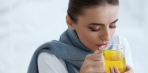 Beautiful Woman With Hot Drink, Drinking Warming Yellow Drink