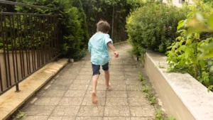 little-boy-running-pool-backyard-scaled